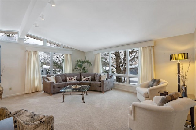 carpeted living room featuring lofted ceiling with beams