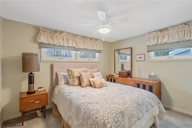 carpeted bedroom with ceiling fan and multiple windows