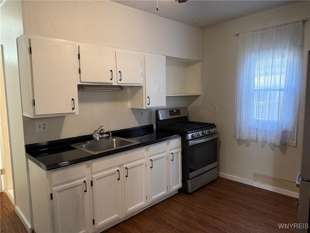 kitchen with white cabinets, stainless steel gas stove, sink, and dark wood-type flooring