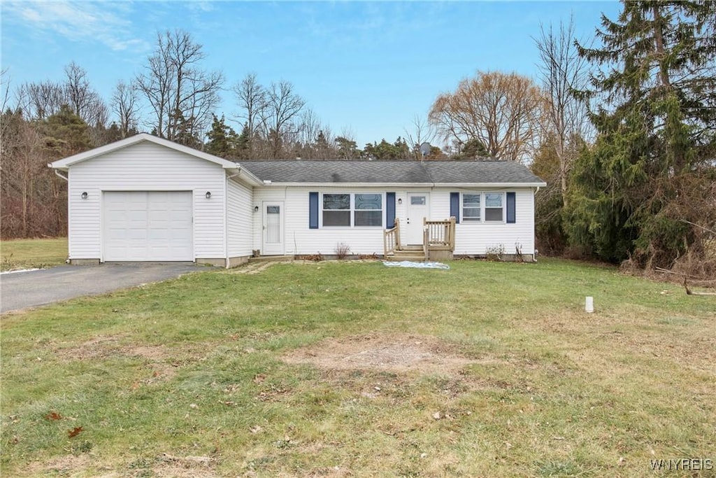 ranch-style home with a front yard and a garage