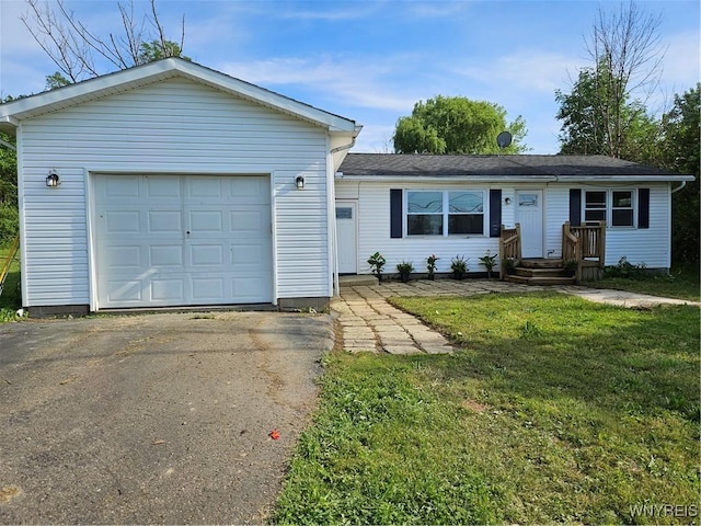 ranch-style house with a garage and a front yard