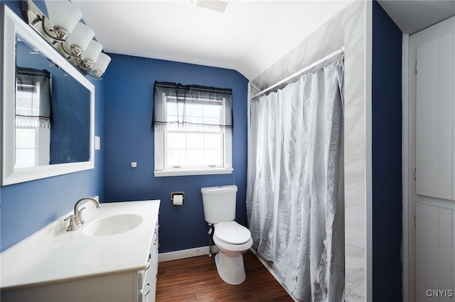 bathroom featuring hardwood / wood-style floors, lofted ceiling, toilet, vanity, and a shower with shower curtain