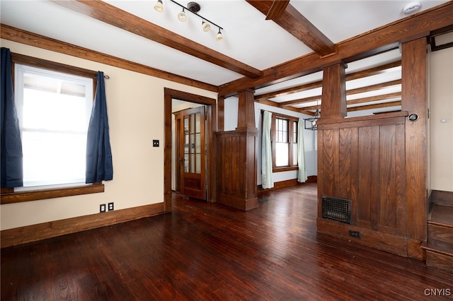 unfurnished room with beamed ceiling and dark wood-type flooring