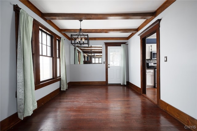 interior space with beam ceiling, dark wood-type flooring, and a notable chandelier