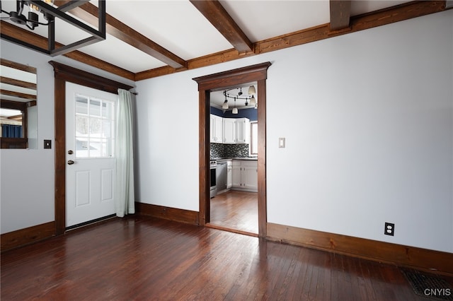 foyer featuring beamed ceiling and dark hardwood / wood-style flooring