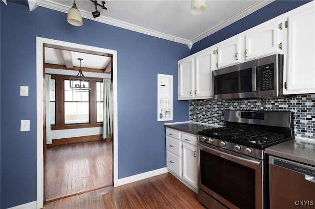 kitchen with white cabinets, backsplash, stainless steel appliances, and an inviting chandelier