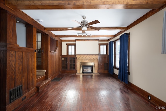 unfurnished living room with ceiling fan, dark hardwood / wood-style flooring, and a brick fireplace