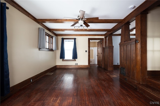 empty room featuring beam ceiling, dark hardwood / wood-style flooring, and ceiling fan