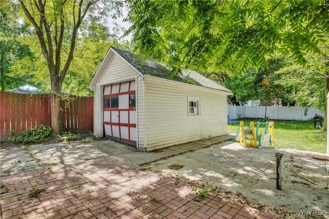 view of outbuilding with a lawn and a garage