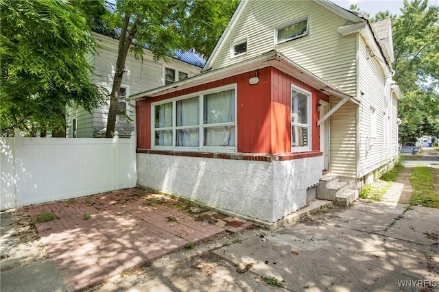 view of property exterior with a patio area