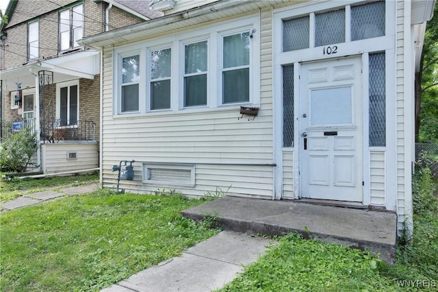 entrance to property featuring a yard and a porch