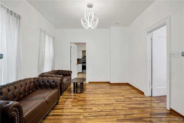 living room featuring wood-type flooring and a notable chandelier