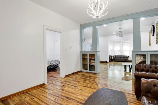 living room with hardwood / wood-style flooring and a notable chandelier