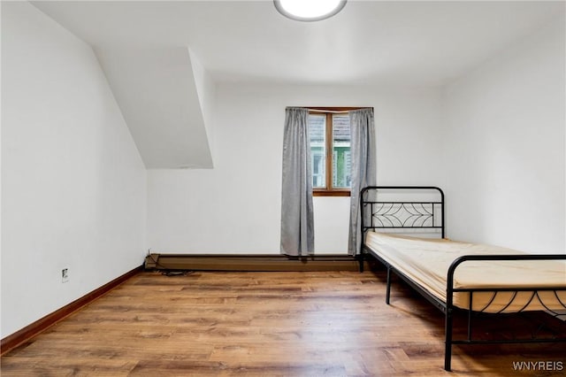 bedroom with hardwood / wood-style flooring