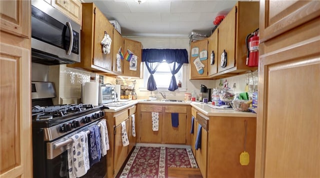 kitchen featuring appliances with stainless steel finishes, backsplash, and sink