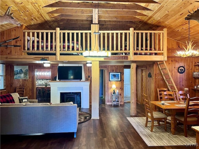 living room featuring wooden walls, wood ceiling, and lofted ceiling