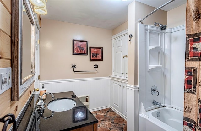 bathroom featuring vanity and shower / bathtub combination with curtain