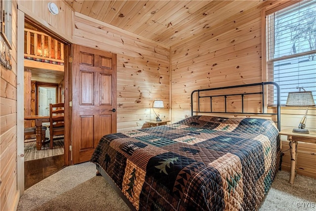 bedroom featuring carpet floors, wooden ceiling, and wood walls