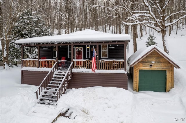 156 S Shore Rd, Webb, NY 13420 - view of front of property featuring a garage, a porch, and stairway