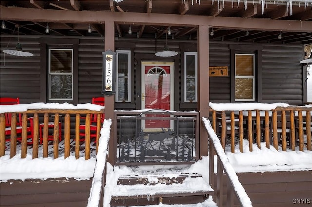156 S Shore Rd, Webb, NY 13420 - snow covered property entrance with a porch