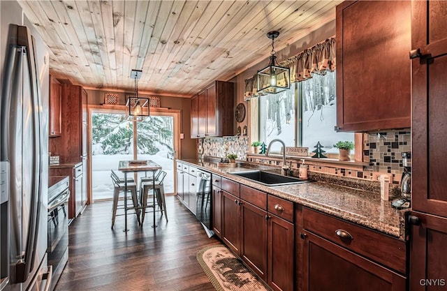 kitchen with wood ceiling, stainless steel fridge, sink, and hanging light fixtures