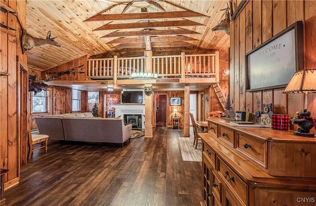 living room featuring wooden walls, dark hardwood / wood-style flooring, high vaulted ceiling, and wooden ceiling