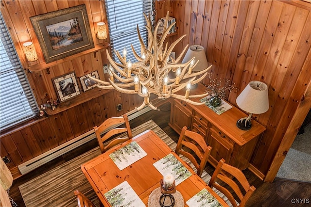 156 S Shore Rd, Webb, NY 13420 - dining space with wooden walls, a notable chandelier, and a healthy amount of sunlight