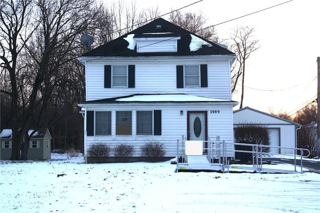 front of property featuring a shed and a garage