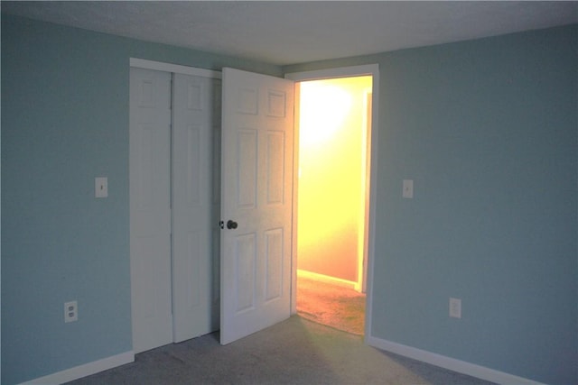 unfurnished bedroom with carpet floors and a closet