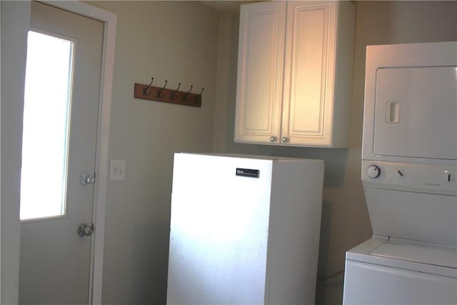 washroom featuring stacked washer / drying machine