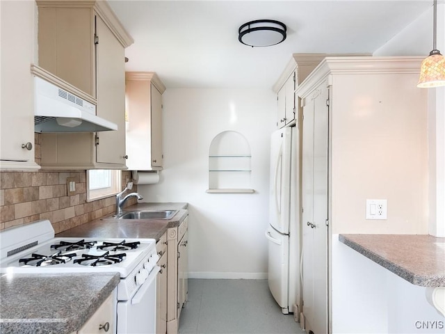 kitchen featuring cream cabinetry, decorative light fixtures, white appliances, and sink