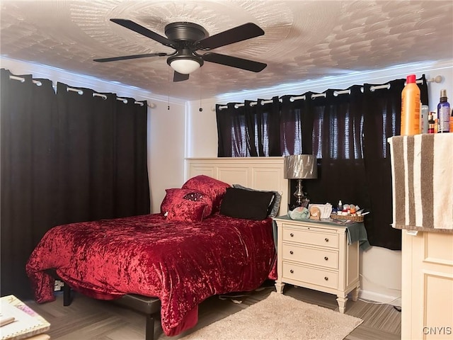 bedroom with ceiling fan, ornamental molding, and a textured ceiling