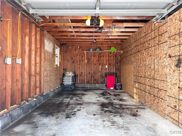 garage featuring wooden walls and a garage door opener