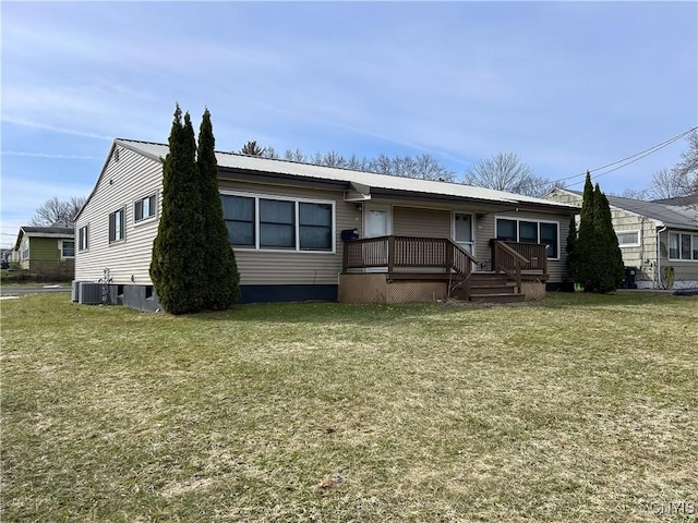 view of front of home with a wooden deck, metal roof, and a front yard