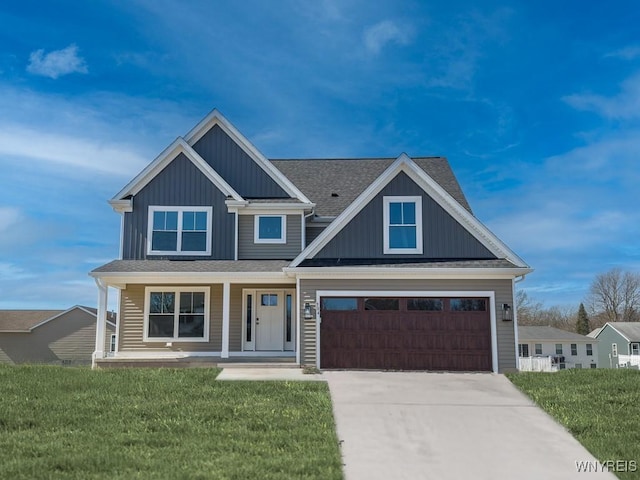 craftsman inspired home with board and batten siding, concrete driveway, a front yard, covered porch, and a garage