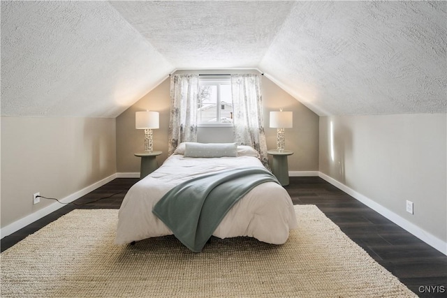 bedroom featuring dark hardwood / wood-style floors, lofted ceiling, and a textured ceiling