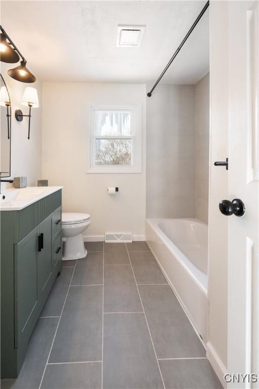 full bathroom with tile patterned floors, vanity, toilet, and tiled shower / bath combo