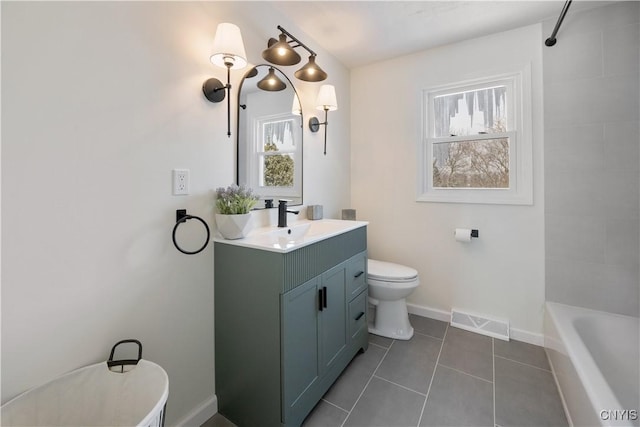 full bathroom featuring tiled shower / bath, tile patterned floors, vanity, and toilet