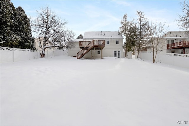 snow covered property featuring a wooden deck