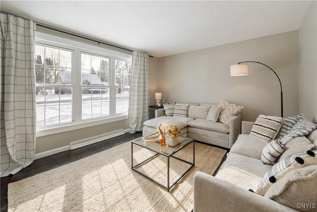 living room with baseboard heating, plenty of natural light, and hardwood / wood-style flooring