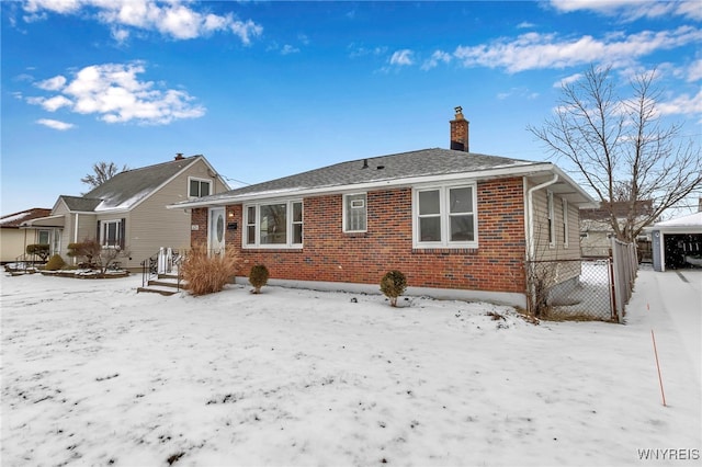 view of snow covered rear of property