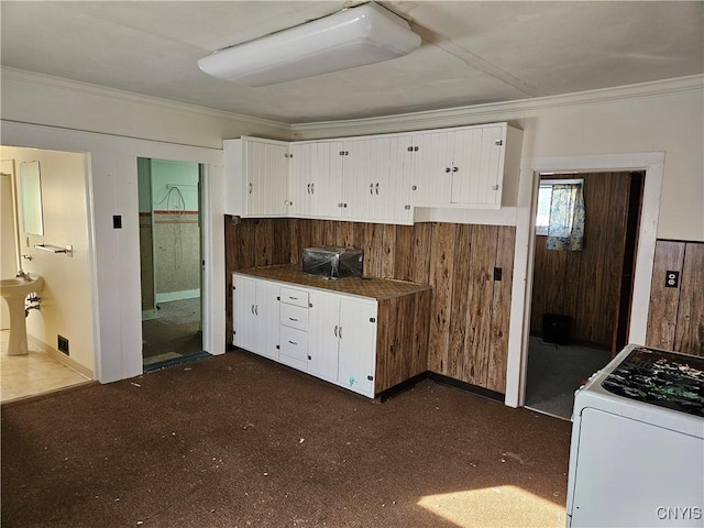 kitchen featuring white cabinetry, white gas stove, and ornamental molding