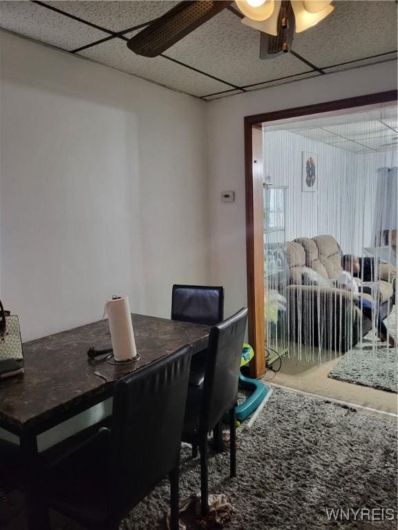 dining room with a paneled ceiling and ceiling fan