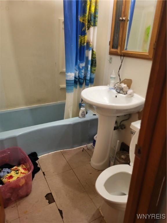 bathroom with tile patterned flooring and shower / tub combo