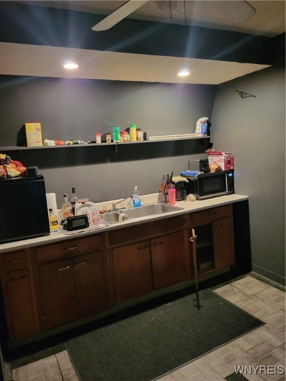 bar featuring dark brown cabinets and sink