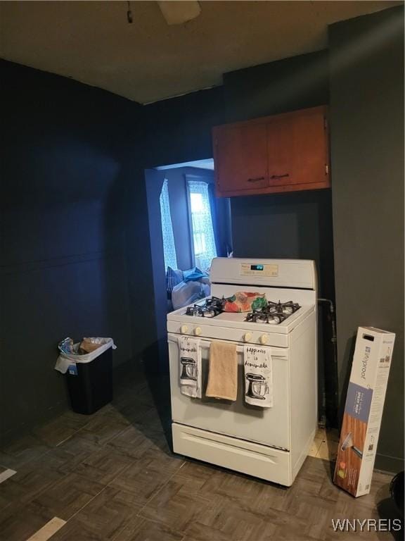 kitchen with white range with gas cooktop and dark parquet floors