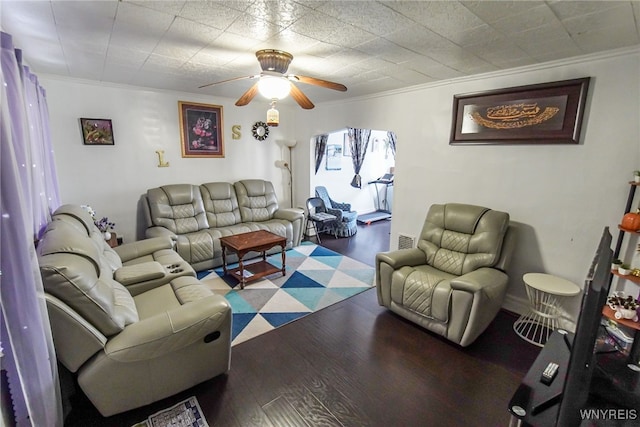 living room featuring crown molding, dark hardwood / wood-style flooring, and ceiling fan