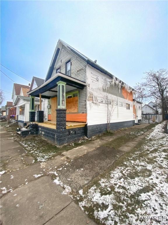 snow covered property with a porch