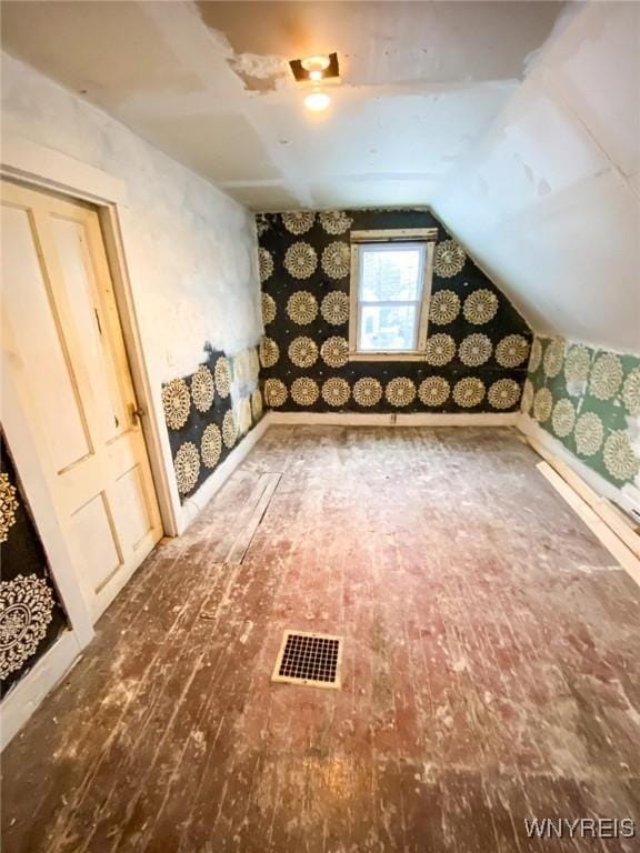 bonus room with vaulted ceiling and hardwood / wood-style floors