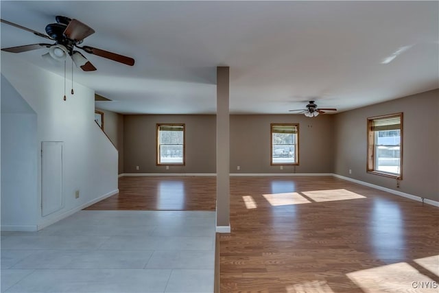 unfurnished living room with ceiling fan, a healthy amount of sunlight, and light hardwood / wood-style floors